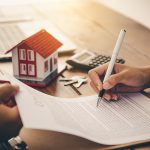 a women signs to refinance her mortgage